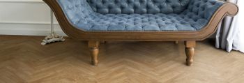 Ornate sofa with oak laminate herringbone flooring